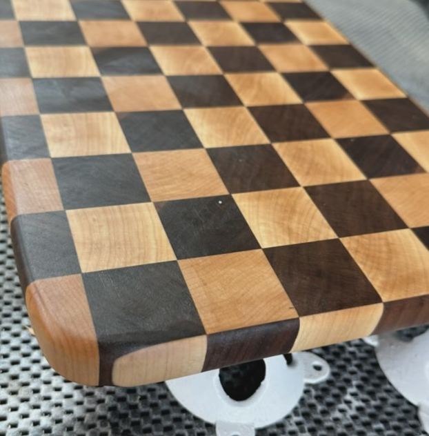 Close-up of a rounded checkerboard end-grain cutting board