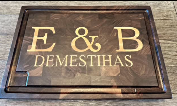 Dark end-grain cutting board personalized with E and B initials