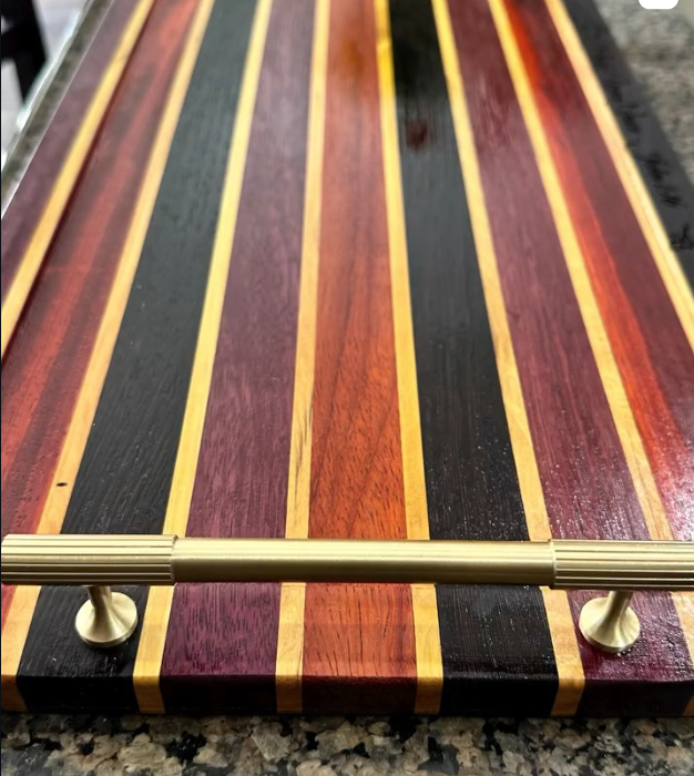 Striped multicolor hardwood serving board with brass handle